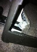 Pull drink tray out to reach bolt